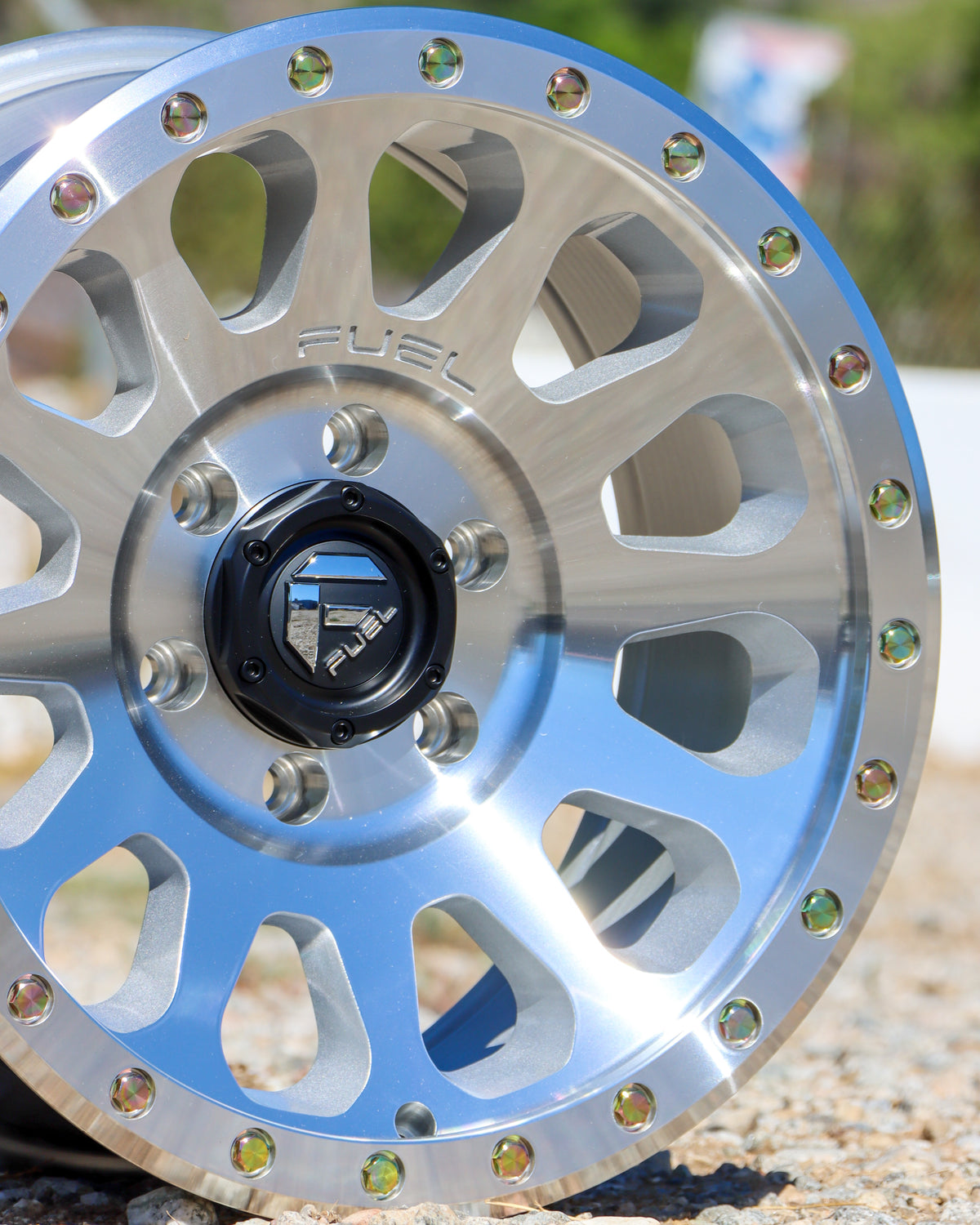 Close-up of the Fuel Syndicate Wheel lying on gravel.