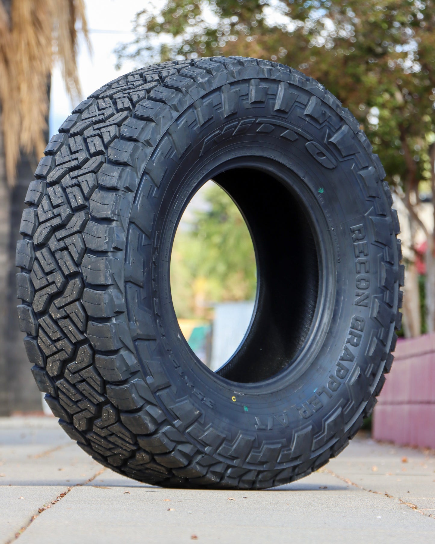 Nitto Recon Grappler sitting in the middle of the sidewalk