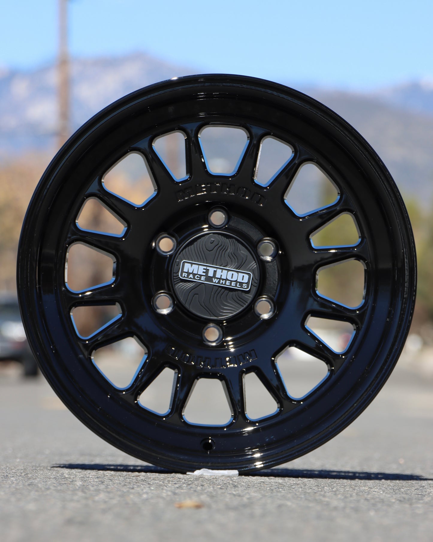 Method MR318 in a Gloss Black finish in the middle if the street.