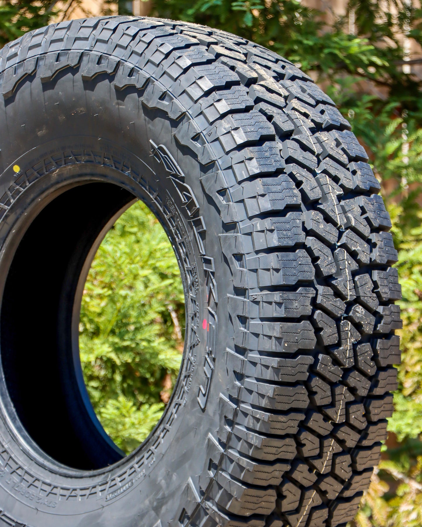 Close-up of Falken Wildpeak AT3 tire displaying the tread and side-wall.