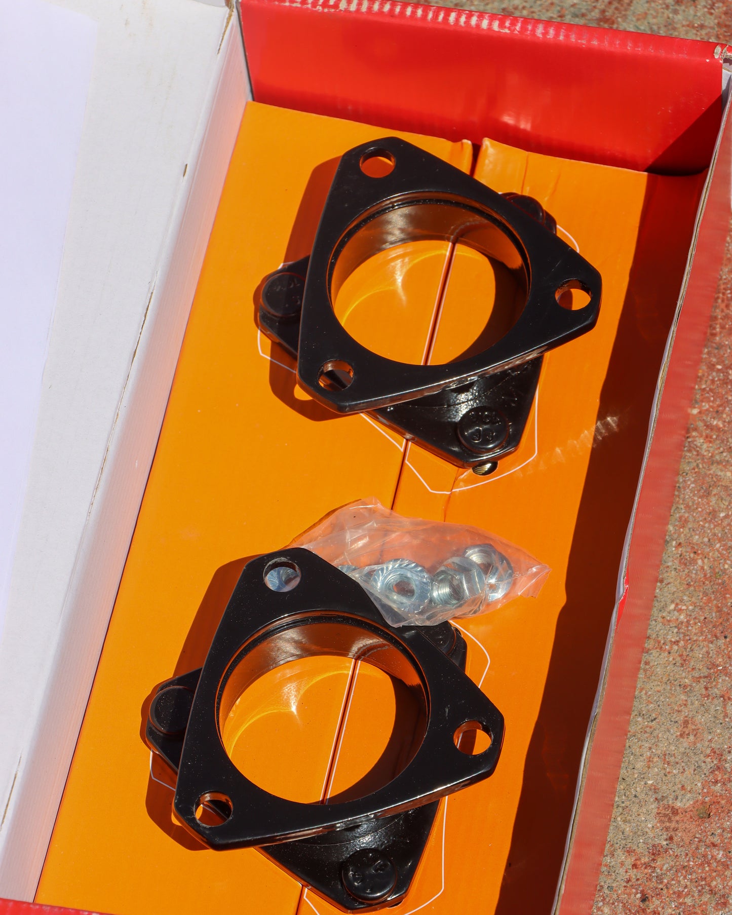 Strut Spacers inside the box with the hardware also in the box.