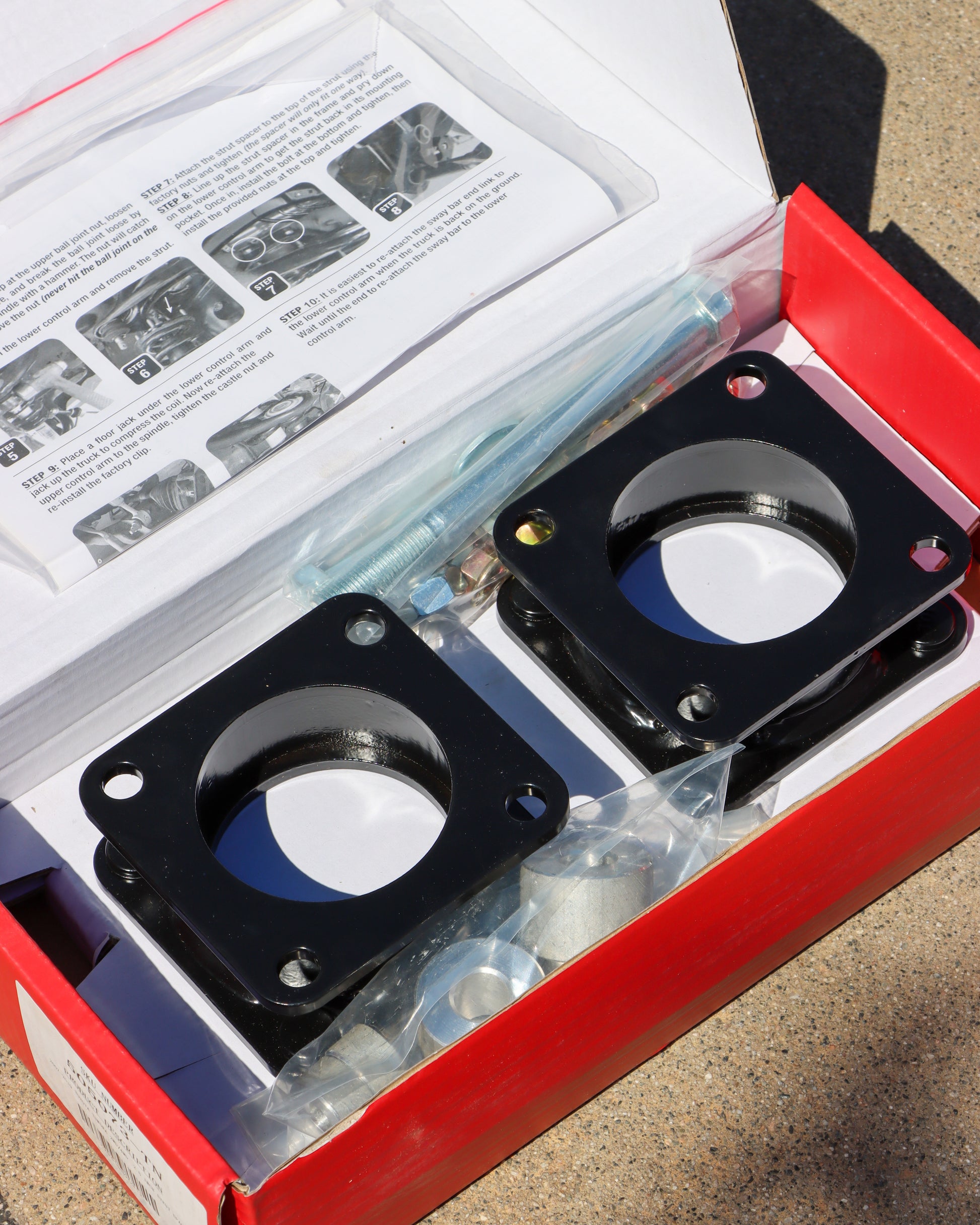 Open Box of the leveling kit with the strut spacers and hardware. 