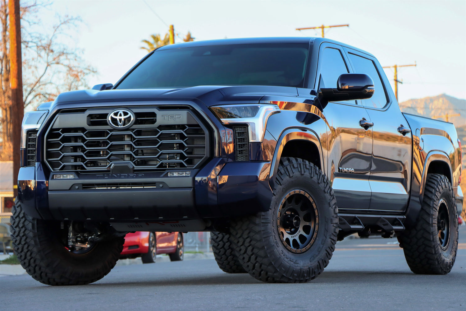 Blue 2022 Toyota Tundra with 37x12.50r17LT Nitto Trail Grapplers on Method MR305 Wheels in a matte black finish.