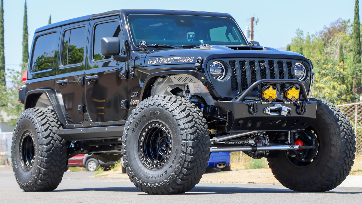 Black 2020 Jeep Wrangler Rubicon lifted with 37x12.50r17LT Toyo Open Country M/T Tires with KMC Grenade Bead lock wheels in a matte black finish.