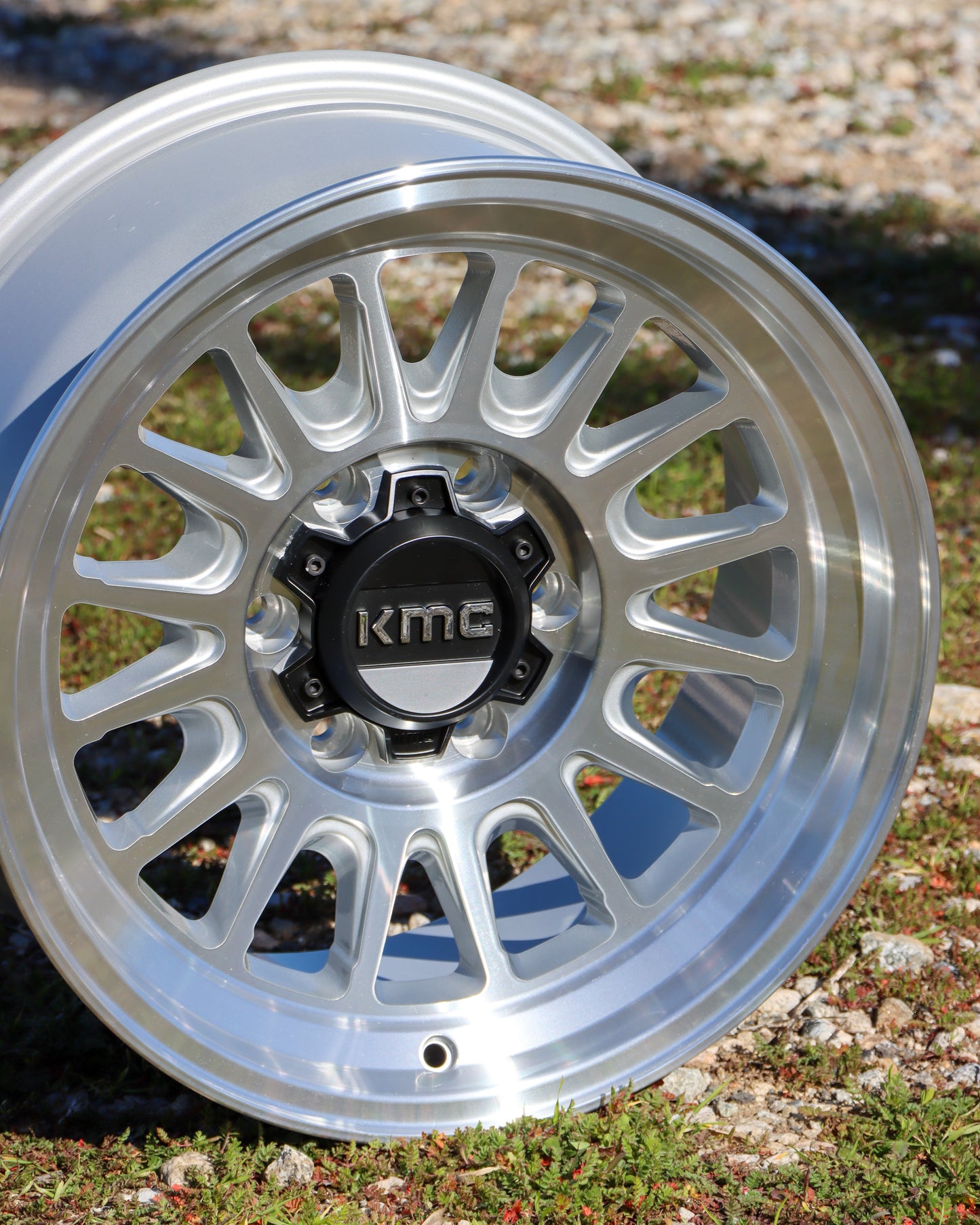 Close up of the KMC Impact OL Wheel in a silver machined finish.