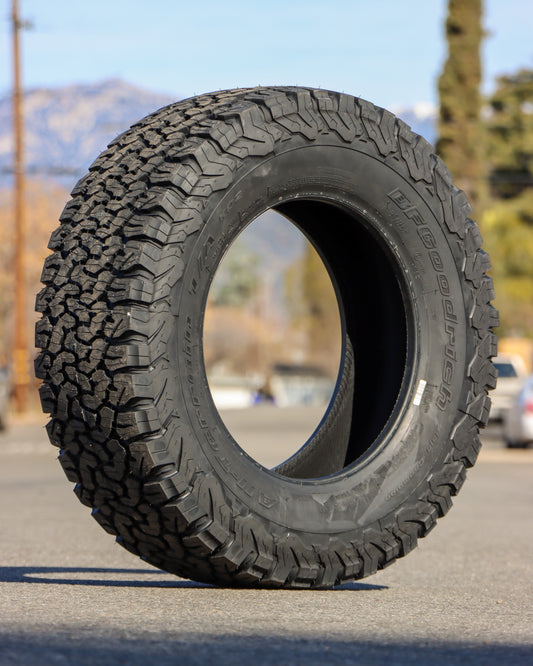 285/65r18LT BFGoodrich all-terrain KO2 sitting in the middle of the street.