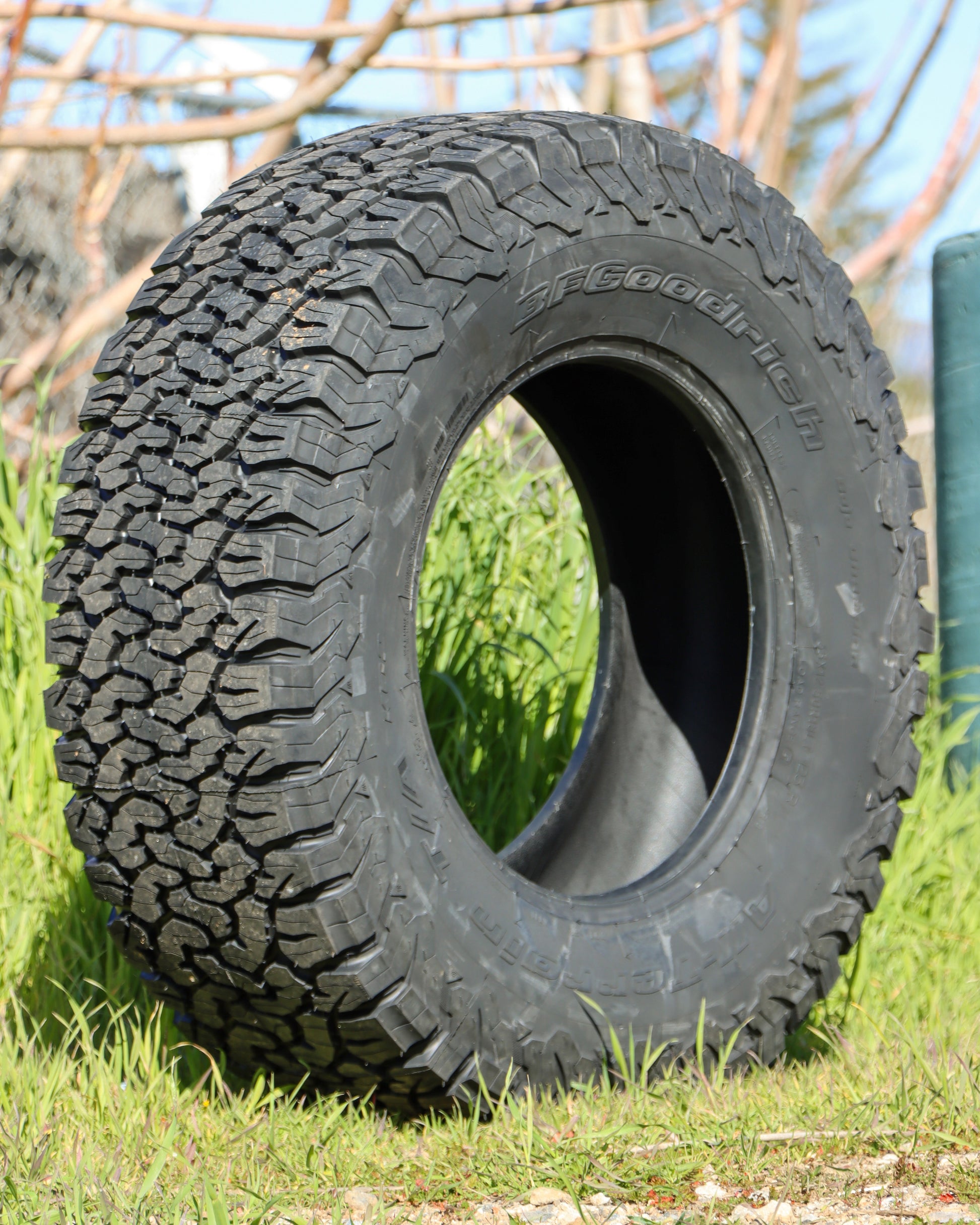 35x12.50r18 BFG KO2 all-terrain tire sitting in some grass.
