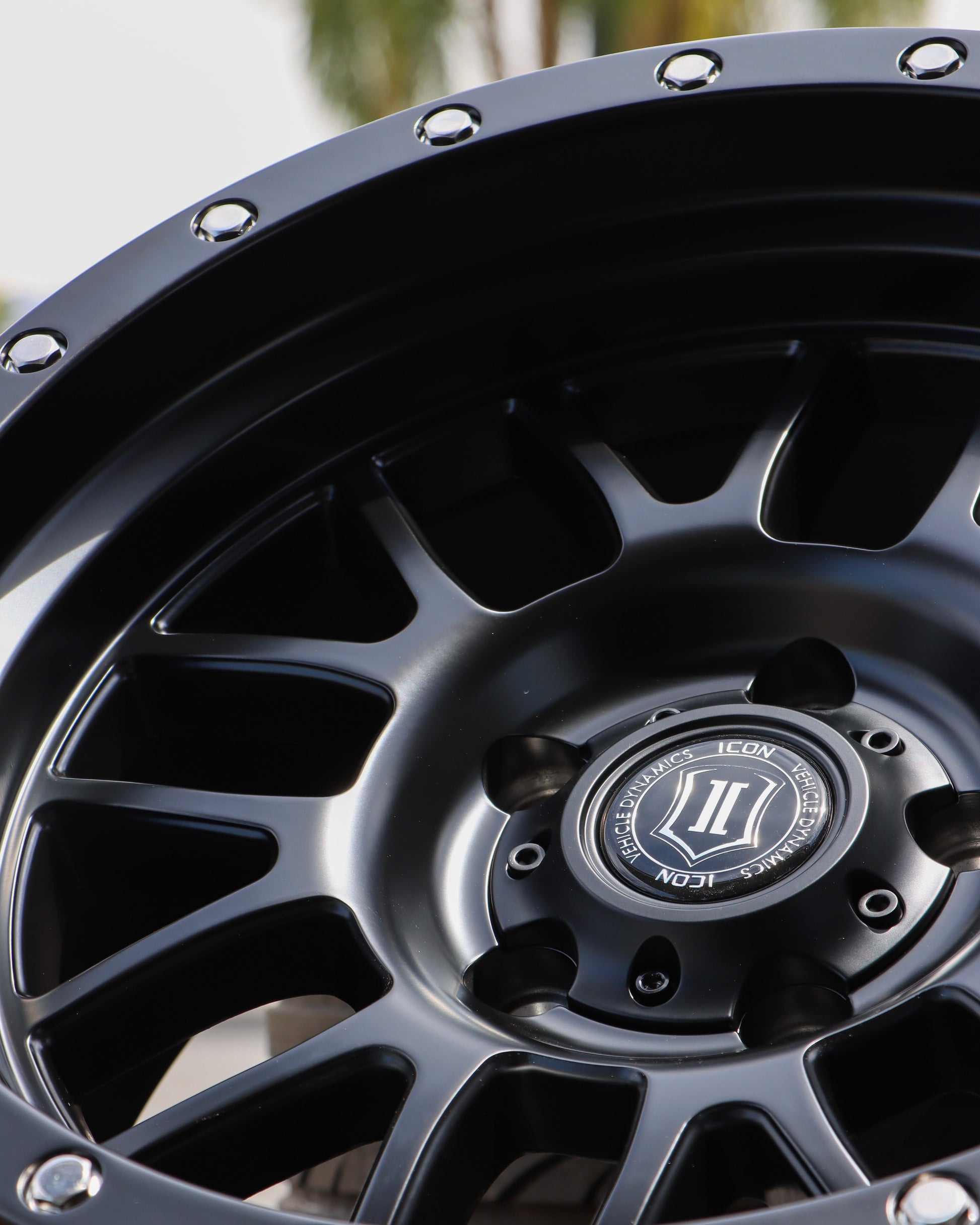 close-up angle view of the Icon Alpha Wheel in a matte black finish.