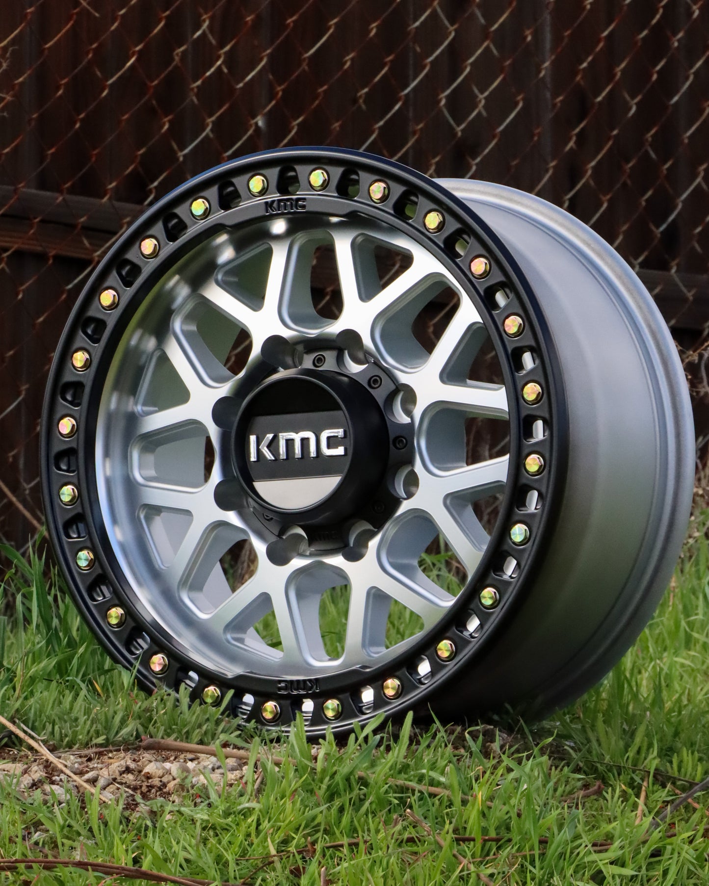 KMC GRS Wheel in a machined finish w/ matte black lip sitting in some grass