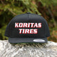 Koritas Tires Classic Snapback sitting ion a rock.