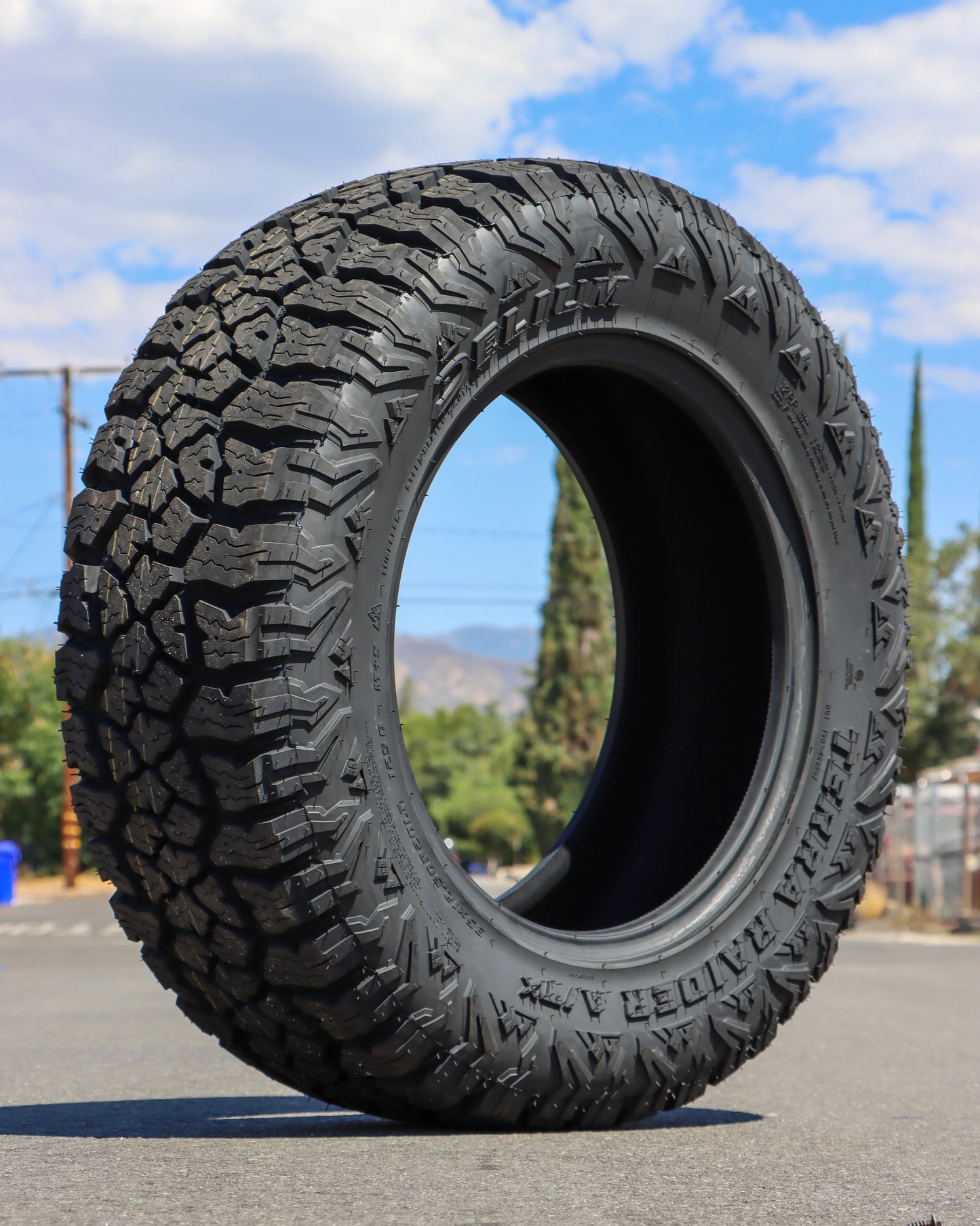 Delium Terra Raider All Terrain Tire on display in the middle of the street.