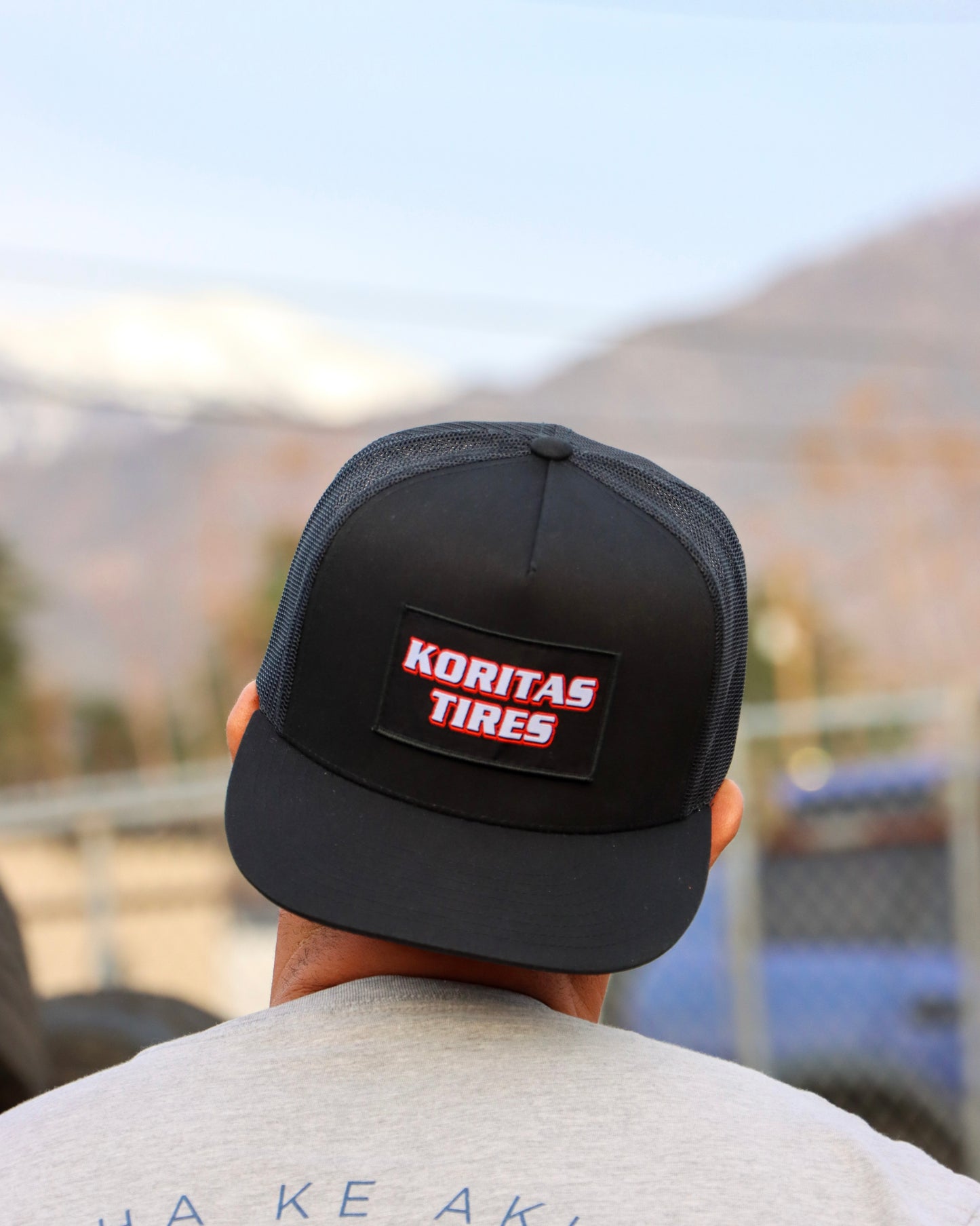 Model with Koritas Tires Trucker hat on backwards