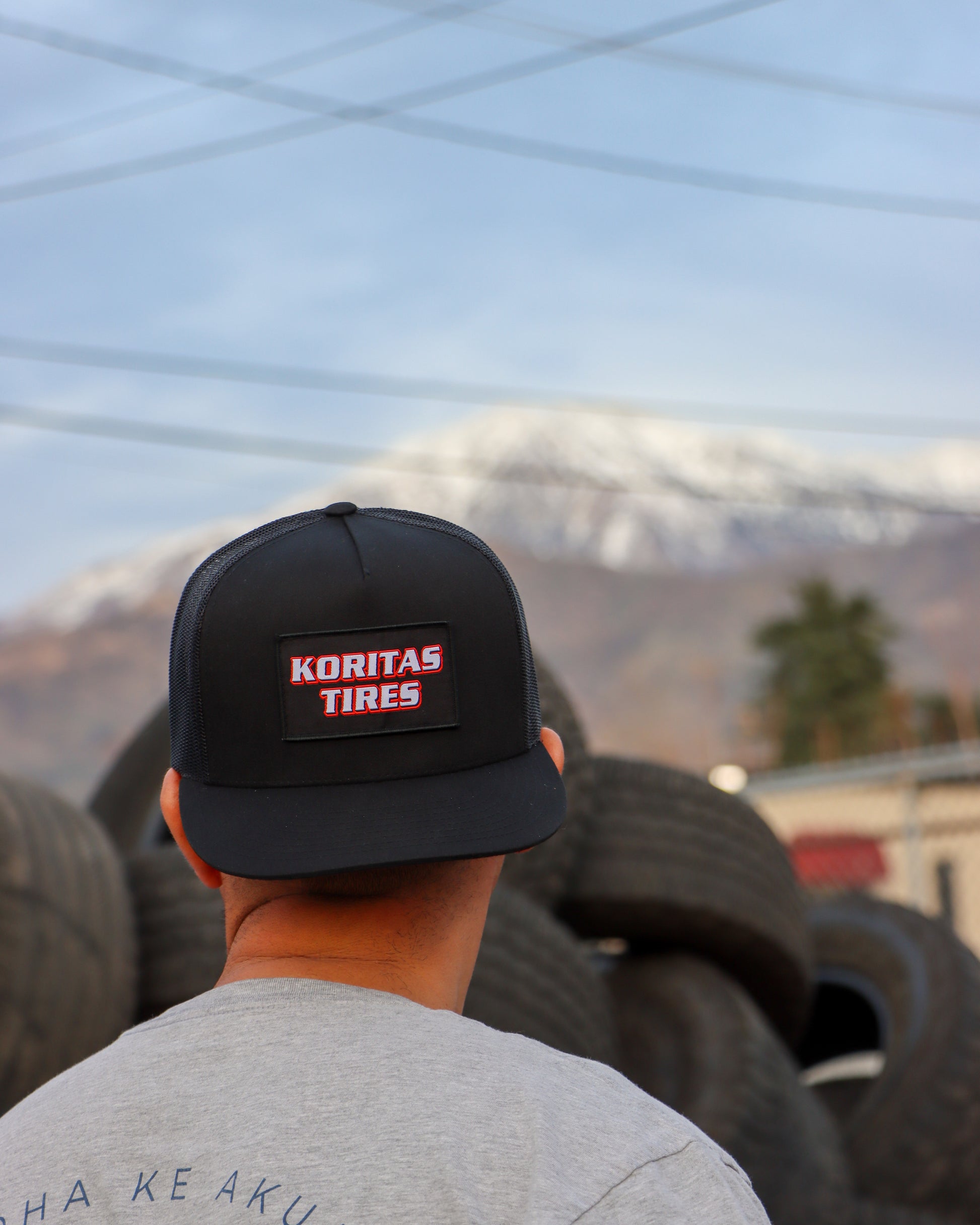 Koritas Tires Trucker Hat on backwards on a model