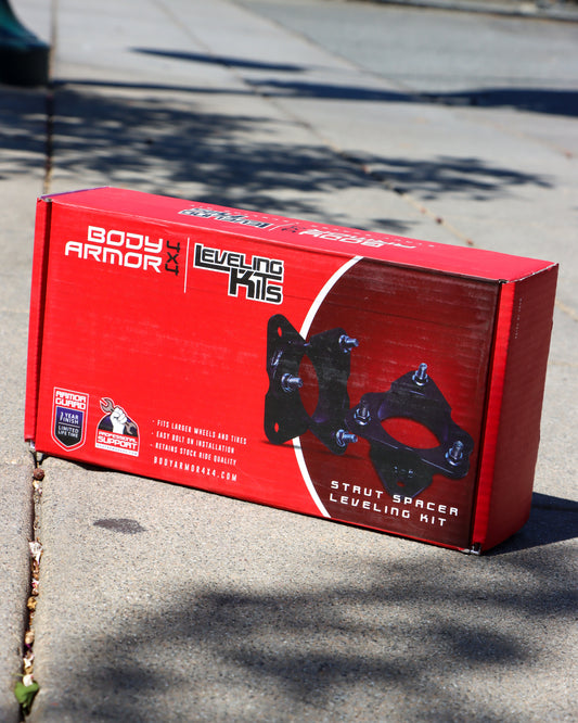Body Armor Leveling Kit box sitting on the sidewalk with an image of the strut spacers on the front.