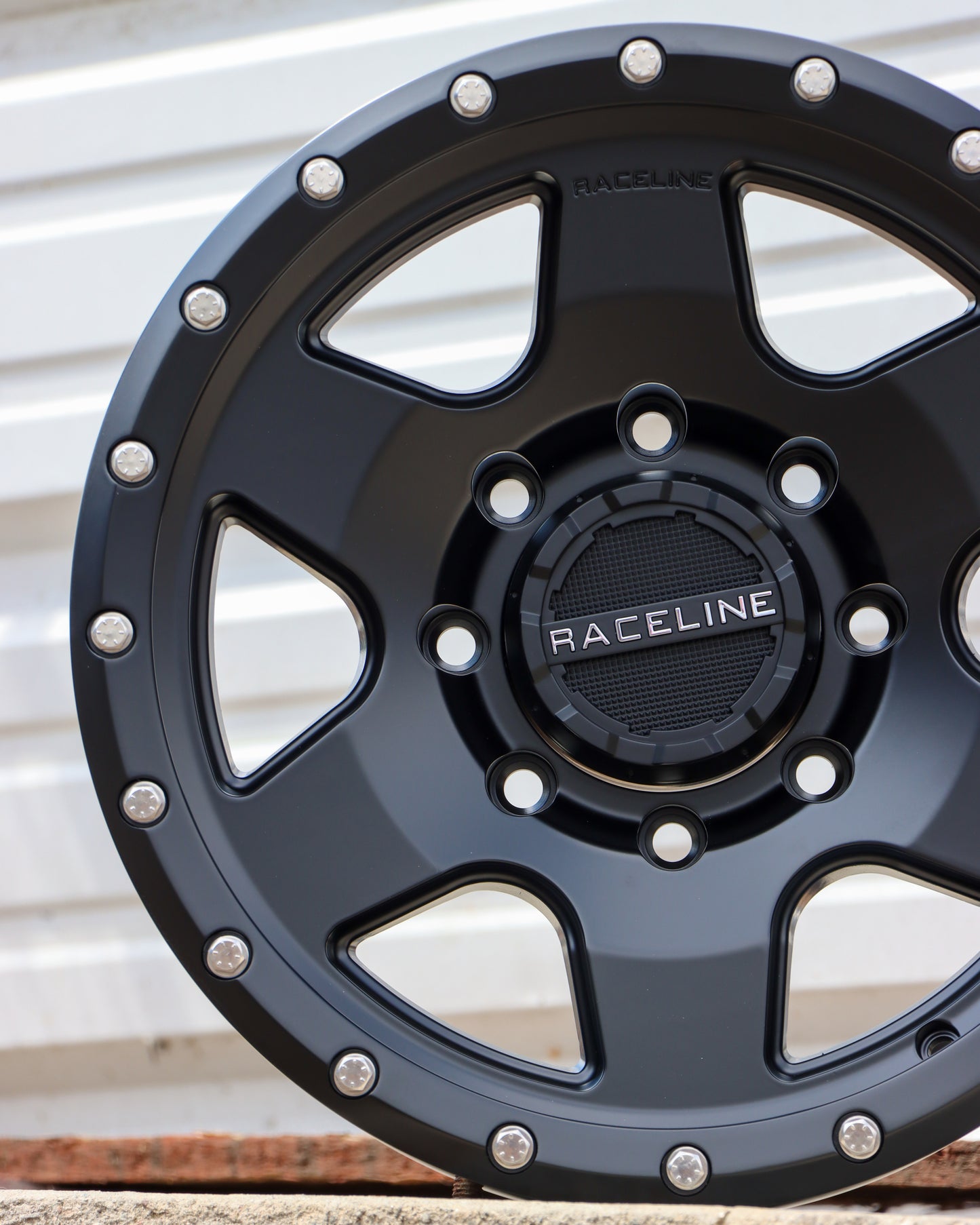 Close-up of the Raceline Boost wheel in a matte black finish.