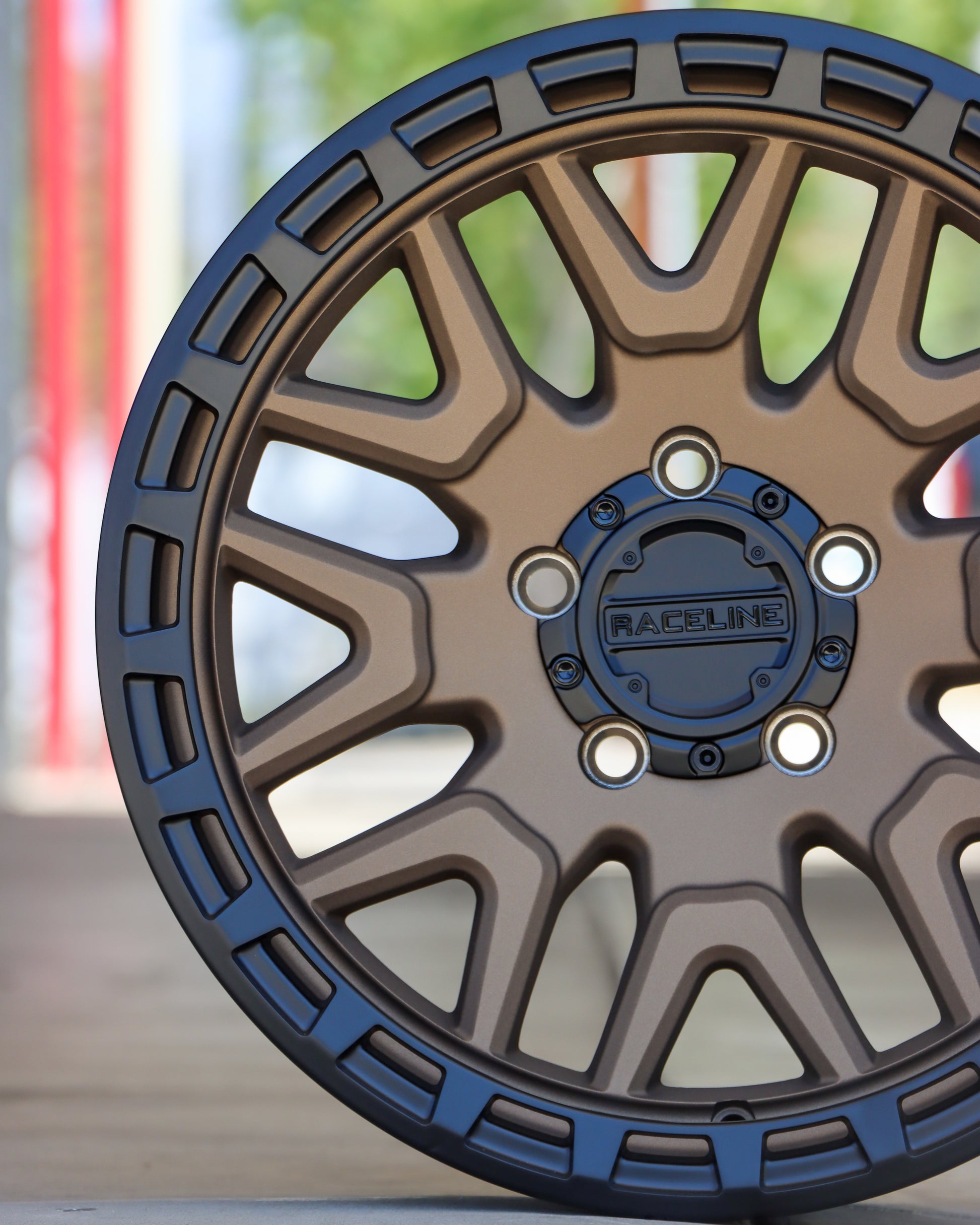 Close-up of the Raceline Krank wheel in a matte bronze finish with a black ring.